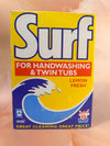 A vintage Surf handwashing and twin tub cleaner box in Lemon Fresh scent, featuring a bright yellow, blue, and red design with a wave graphic.