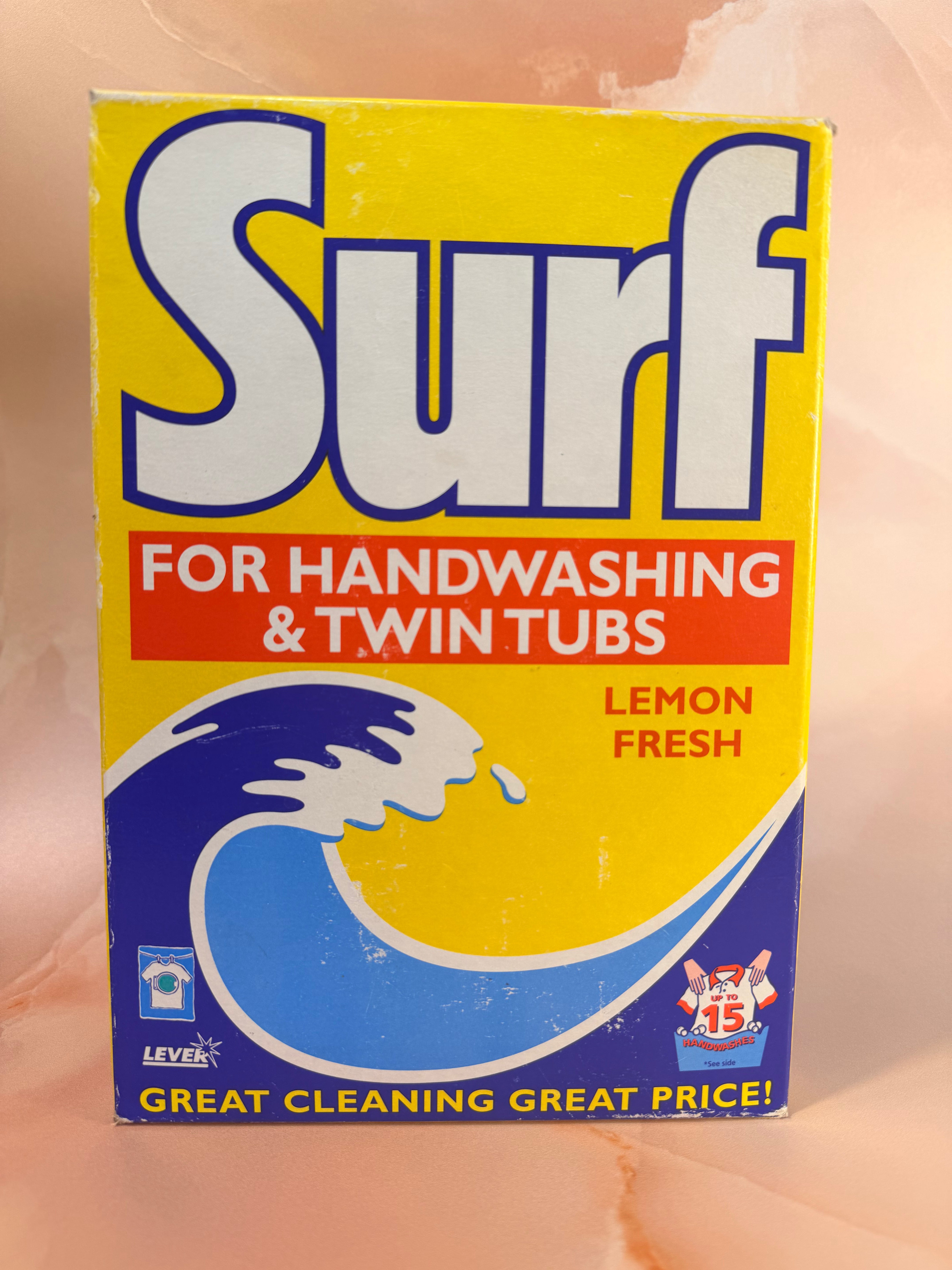 A vintage Surf handwashing and twin tub cleaner box in Lemon Fresh scent, featuring a bright yellow, blue, and red design with a wave graphic.